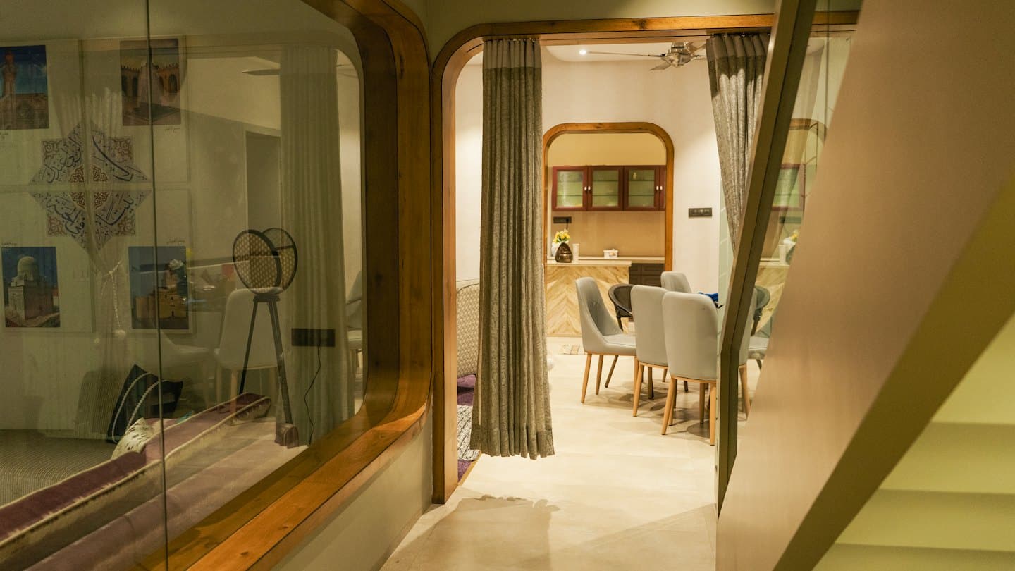 Modern open plan home interior viewed through a wooden archway.